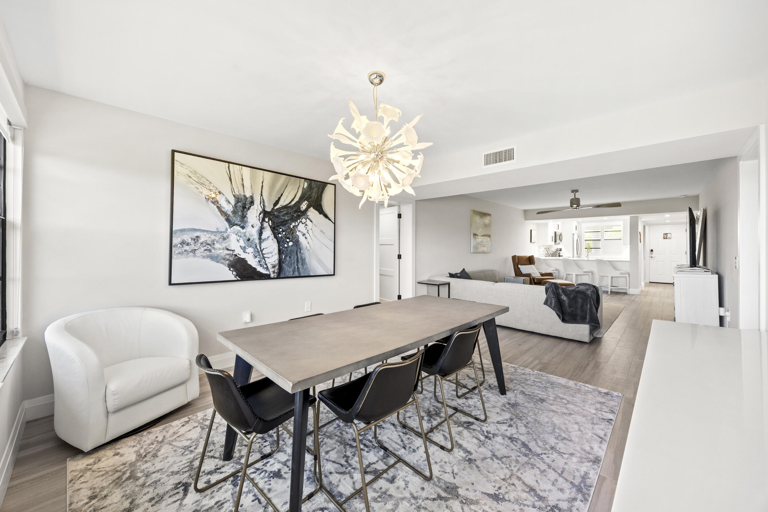 6061 Balboa Circle, Unit 403 Boca Raton, FL 33433 - Photo 21 of 44 a view of a dining room with furniture and a chandelier