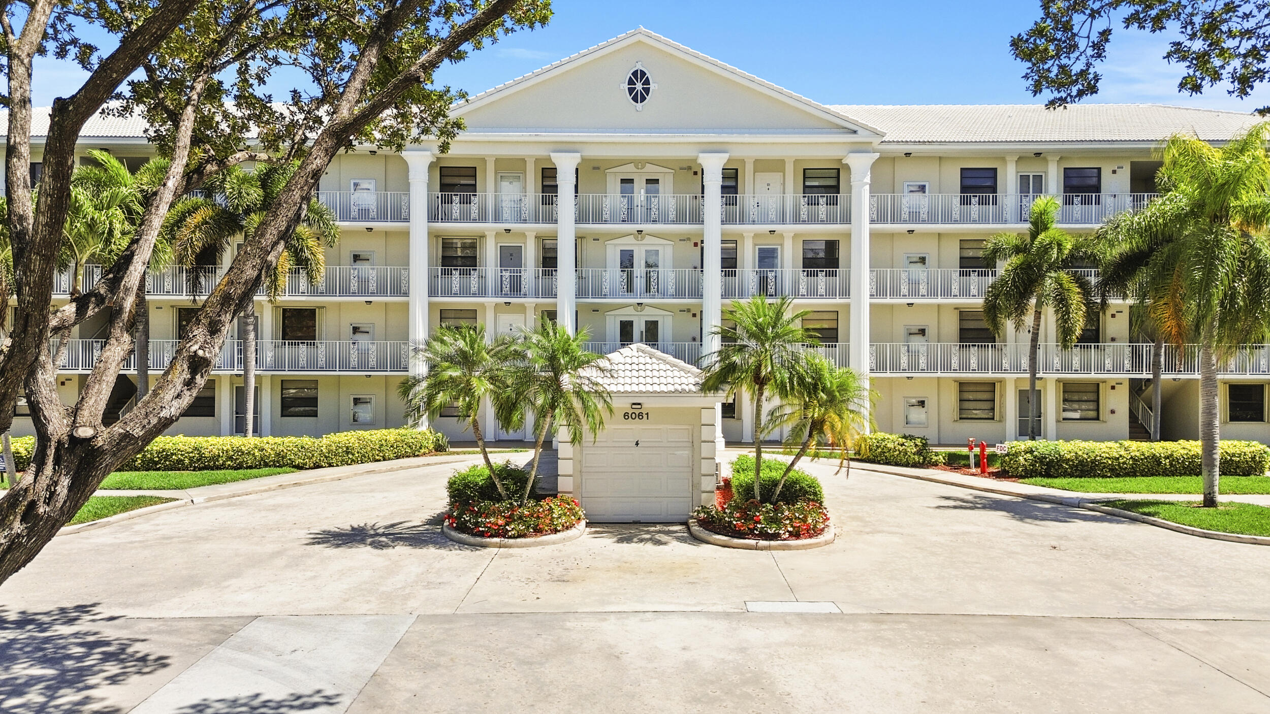 6061 Balboa Circle, Unit 403 Boca Raton, FL 33433 - Photo 35 of 44 a front view of building with street