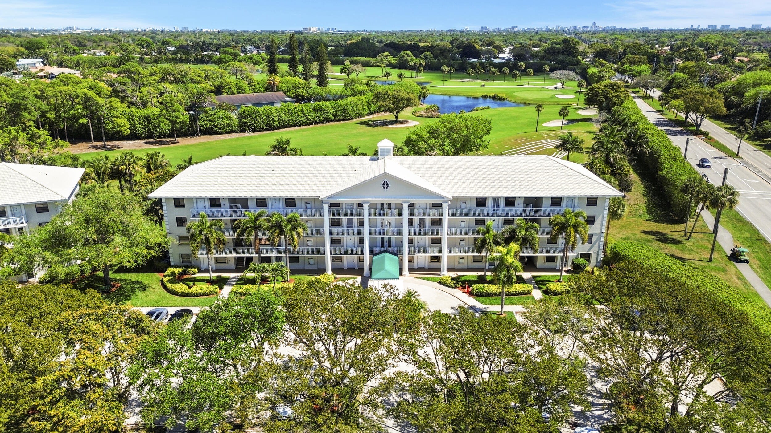 6061 Balboa Circle, Unit 403 Boca Raton, FL 33433 - Photo 36 of 44 an outdoor space with lots of palm trees