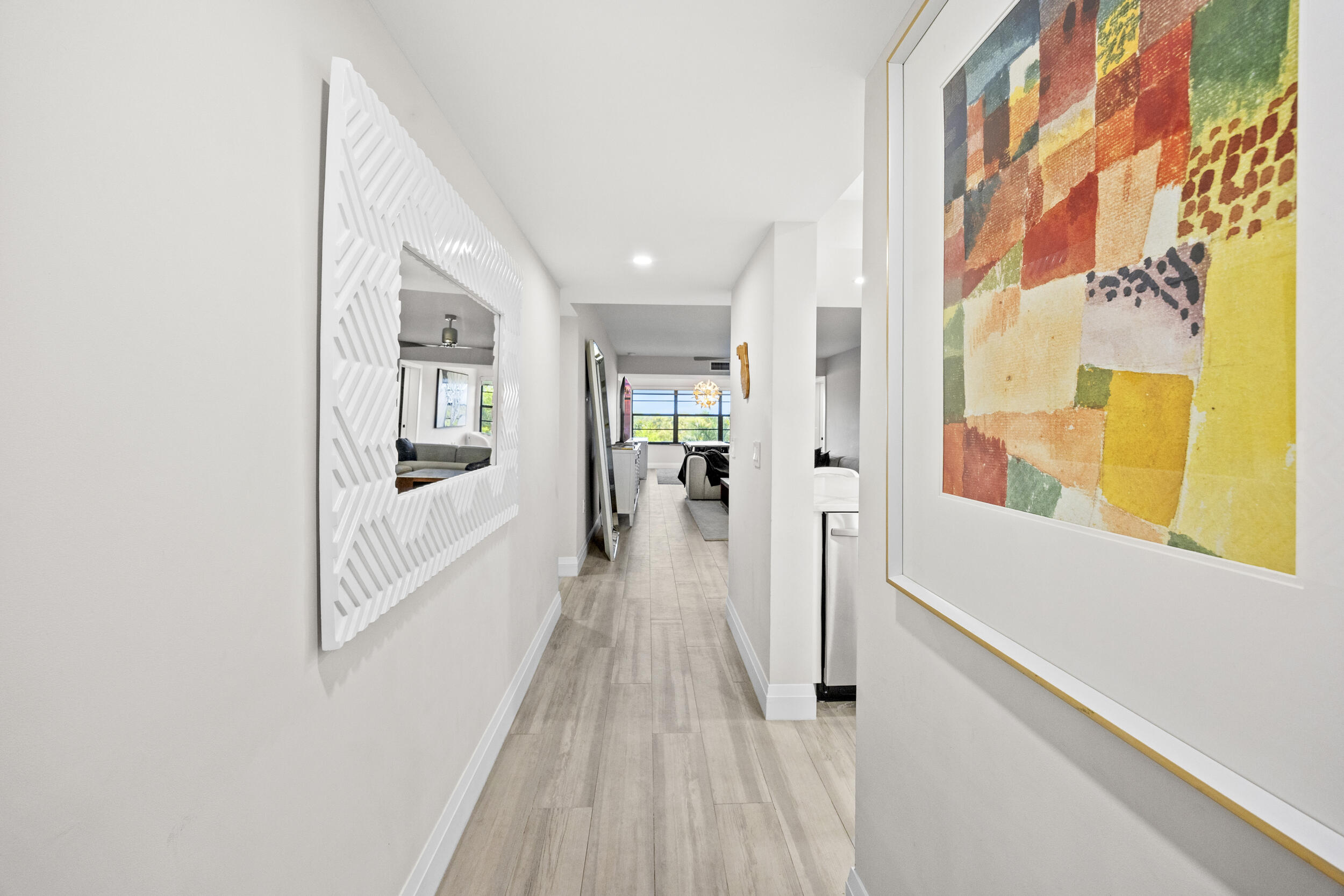 6061 Balboa Circle, Unit 403 Boca Raton, FL 33433 - Photo 5 of 44 a view of a hallway with wooden floor and windows