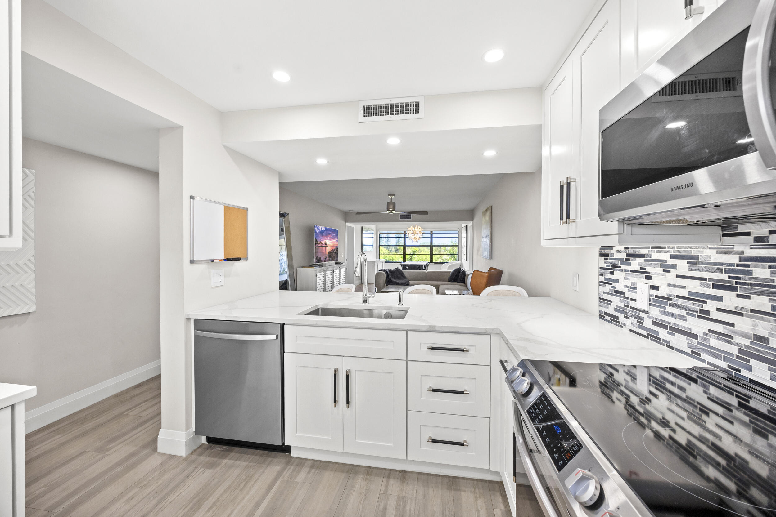 6061 Balboa Circle, Unit 403 Boca Raton, FL 33433 - Photo 10 of 44 a kitchen with stainless steel appliances a sink stove and cabinets