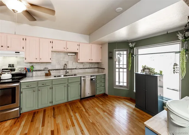 a kitchen with stainless steel appliances a refrigerator and a sink