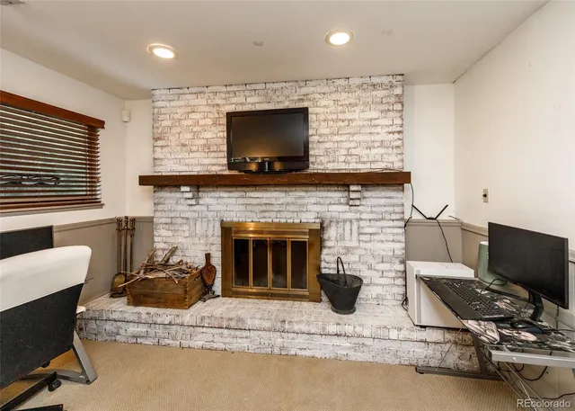 a view of a livingroom with furniture and a fireplace