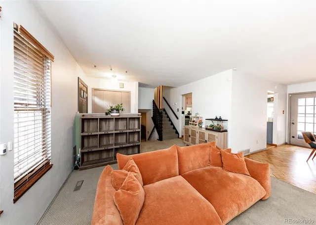 a living room with furniture a rug and a flat screen tv