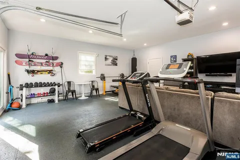 a room with gym equipment and a flat screen tv