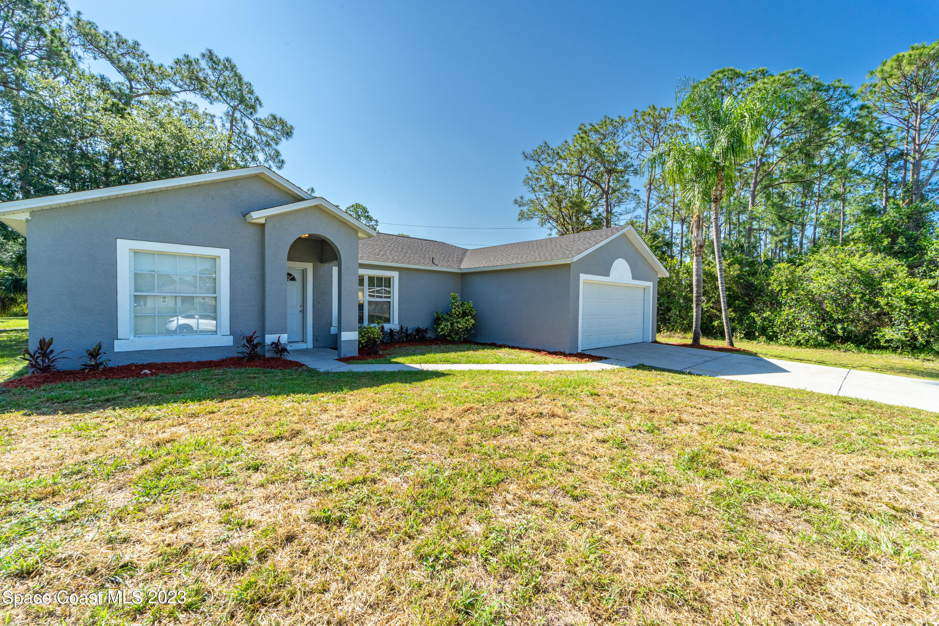 215 Trilby Road Southwest Palm Bay, FL 32908 - Photo 1 of 19 a house view with swimming pool in front of it