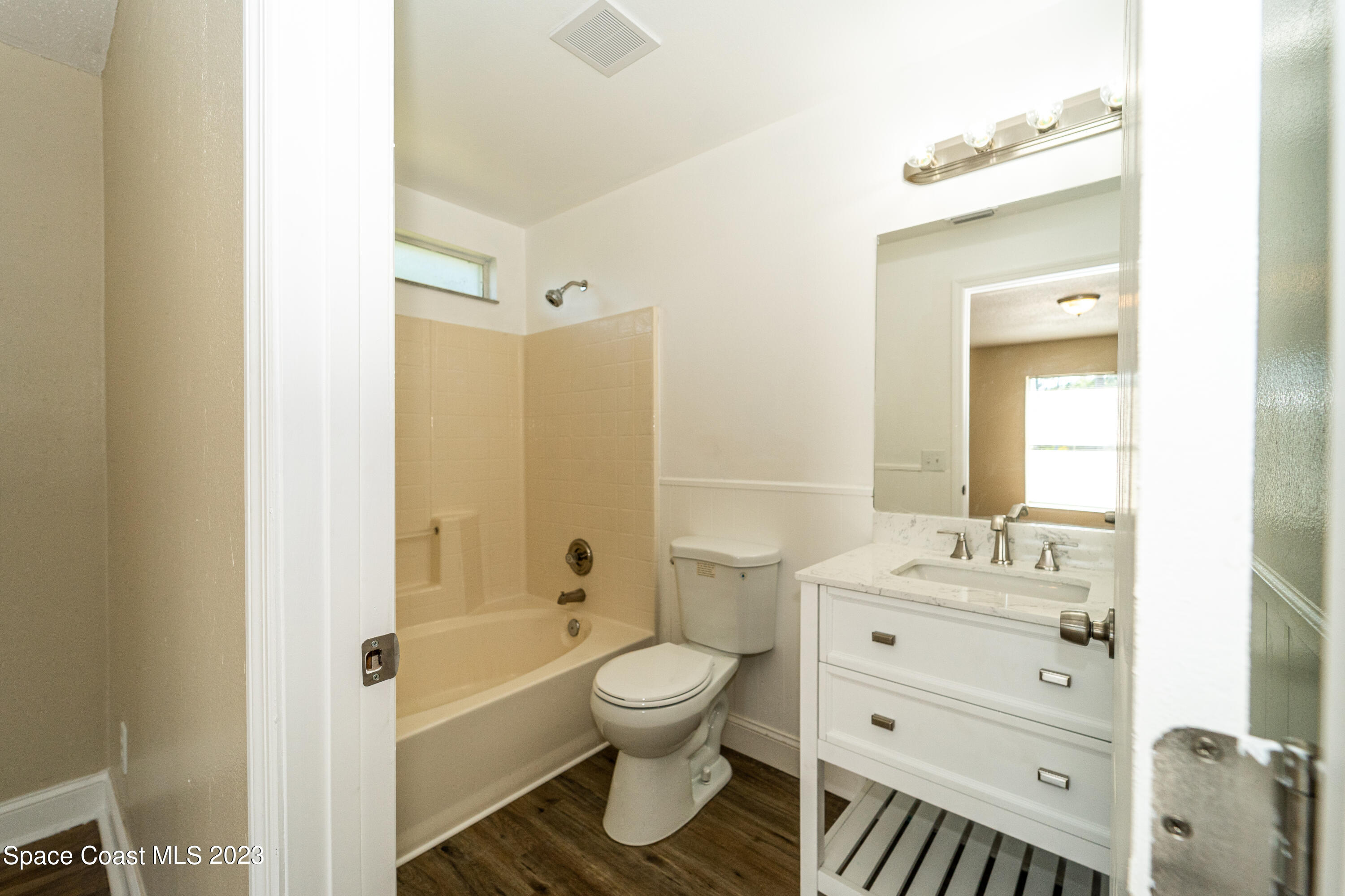215 Trilby Road Southwest Palm Bay, FL 32908 - Photo 13 of 19 a bathroom with a sink toilet a shower and a mirror