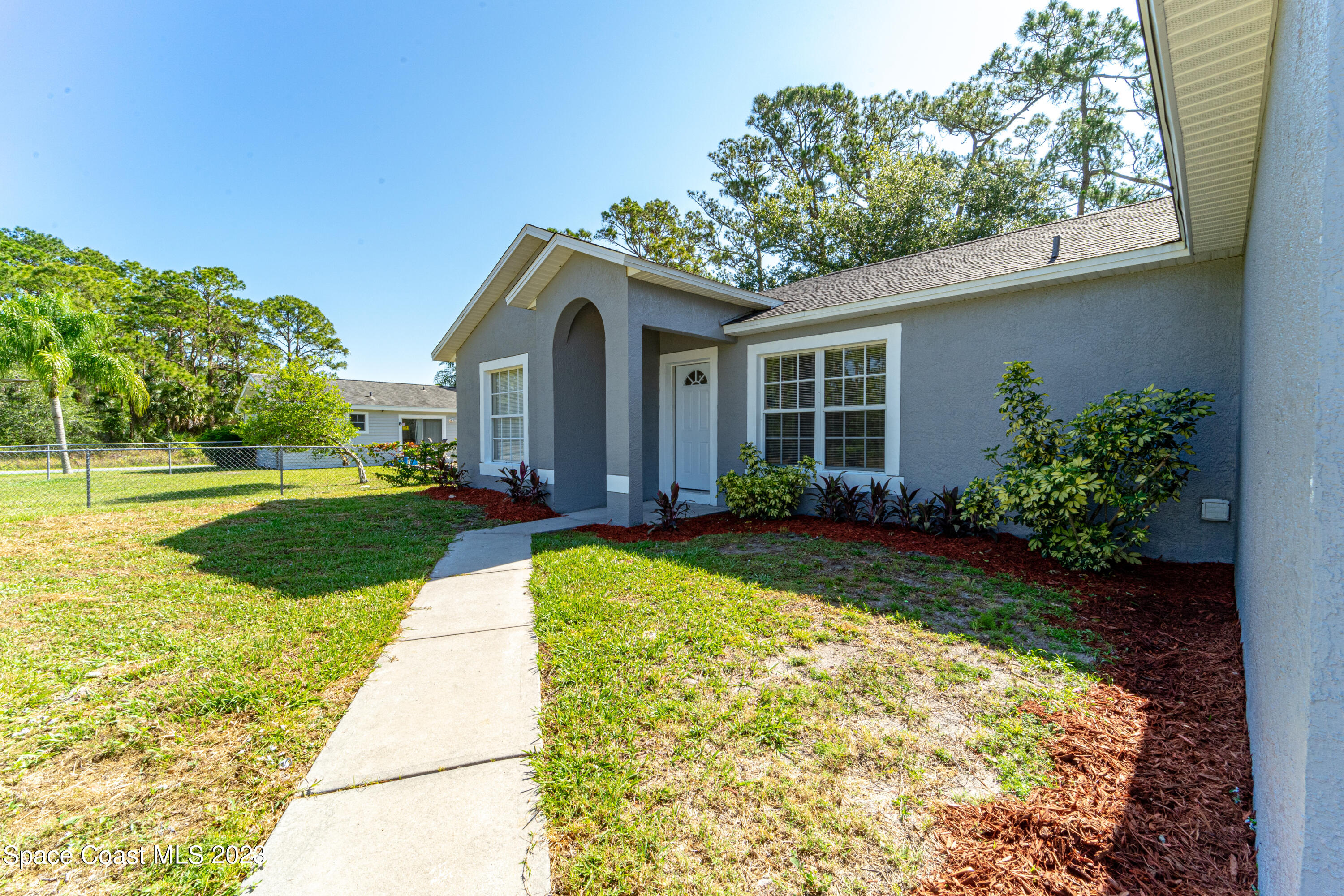 215 Trilby Road Southwest Palm Bay, FL 32908 - Photo 2 of 19 a view of house with yard and green space