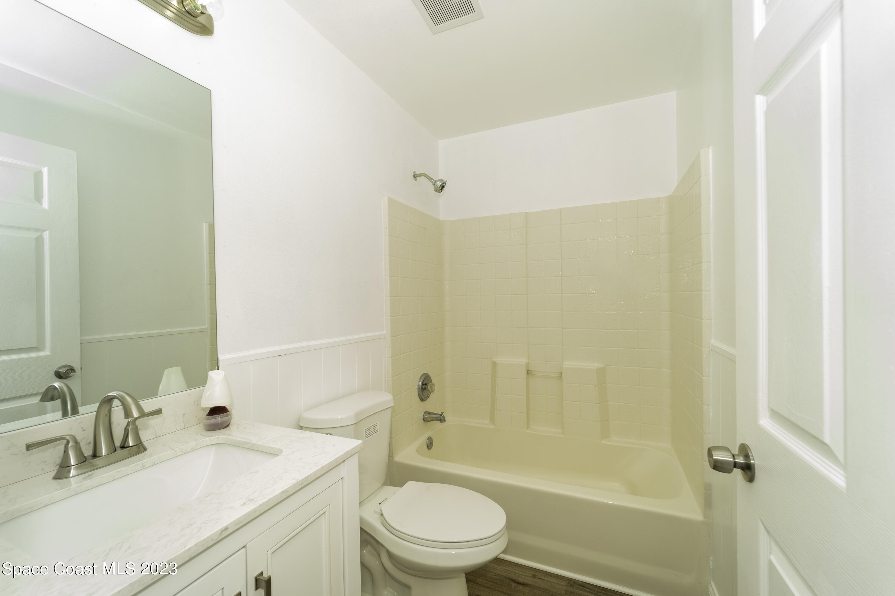 215 Trilby Road Southwest Palm Bay, FL 32908 - Photo 6 of 19 a bathroom with a granite countertop sink a toilet and shower