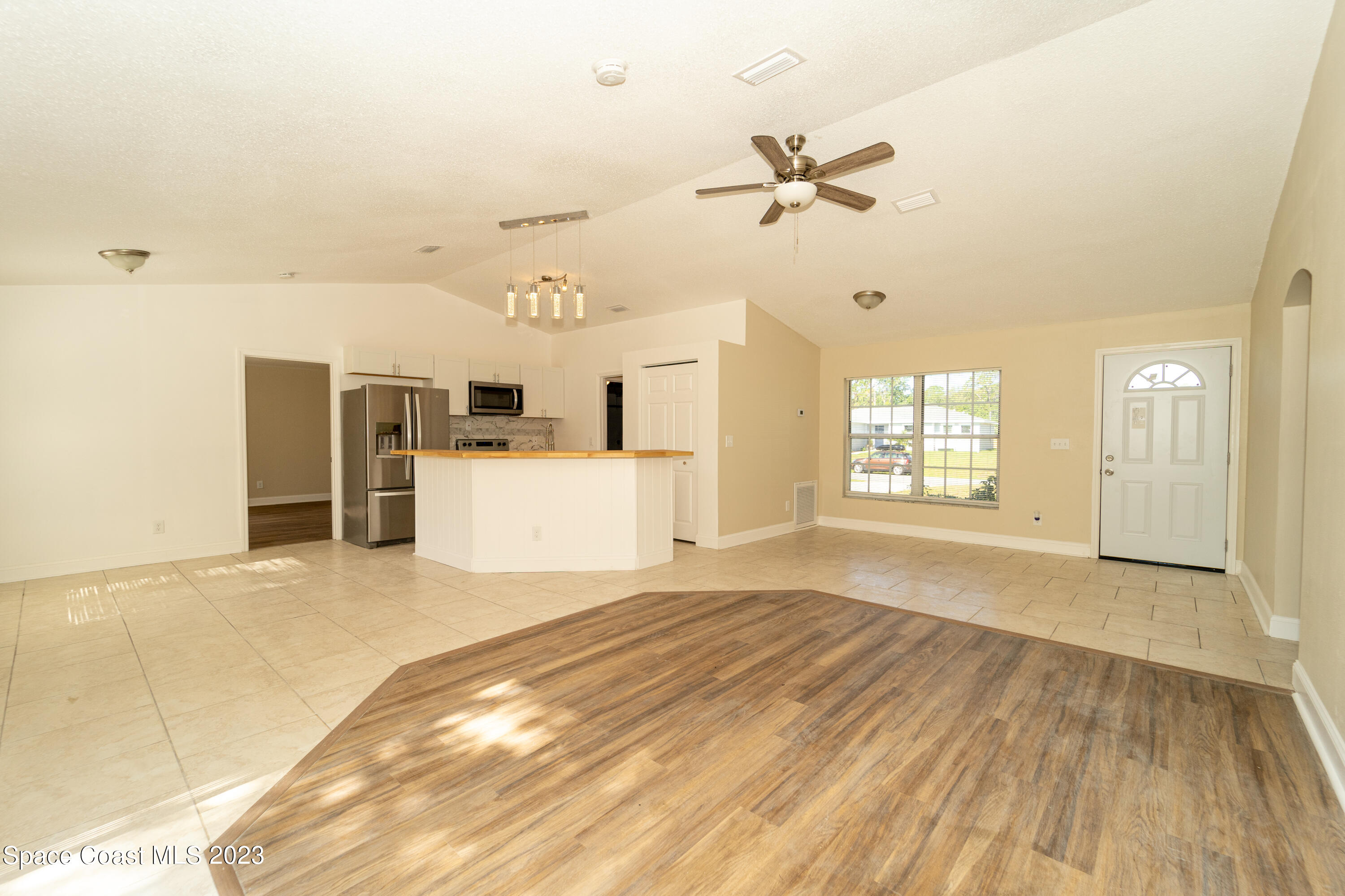 215 Trilby Road Southwest Palm Bay, FL 32908 - Photo 9 of 19 a view of a livingroom with a kitchen and a window