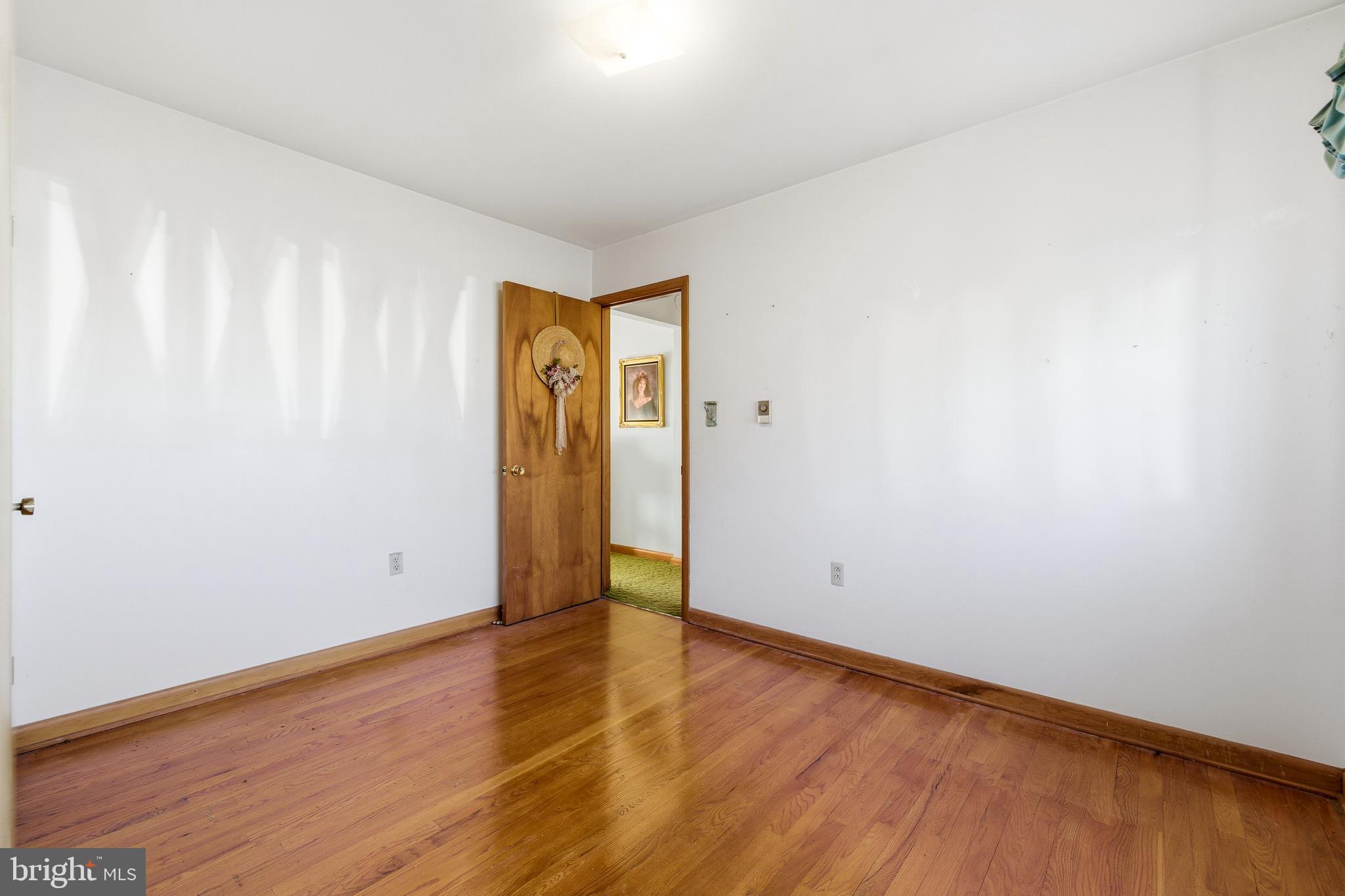 115 Sunset Drive Stanley, VA 22851 - Photo 22 of 56 a view of an empty room with wooden floor