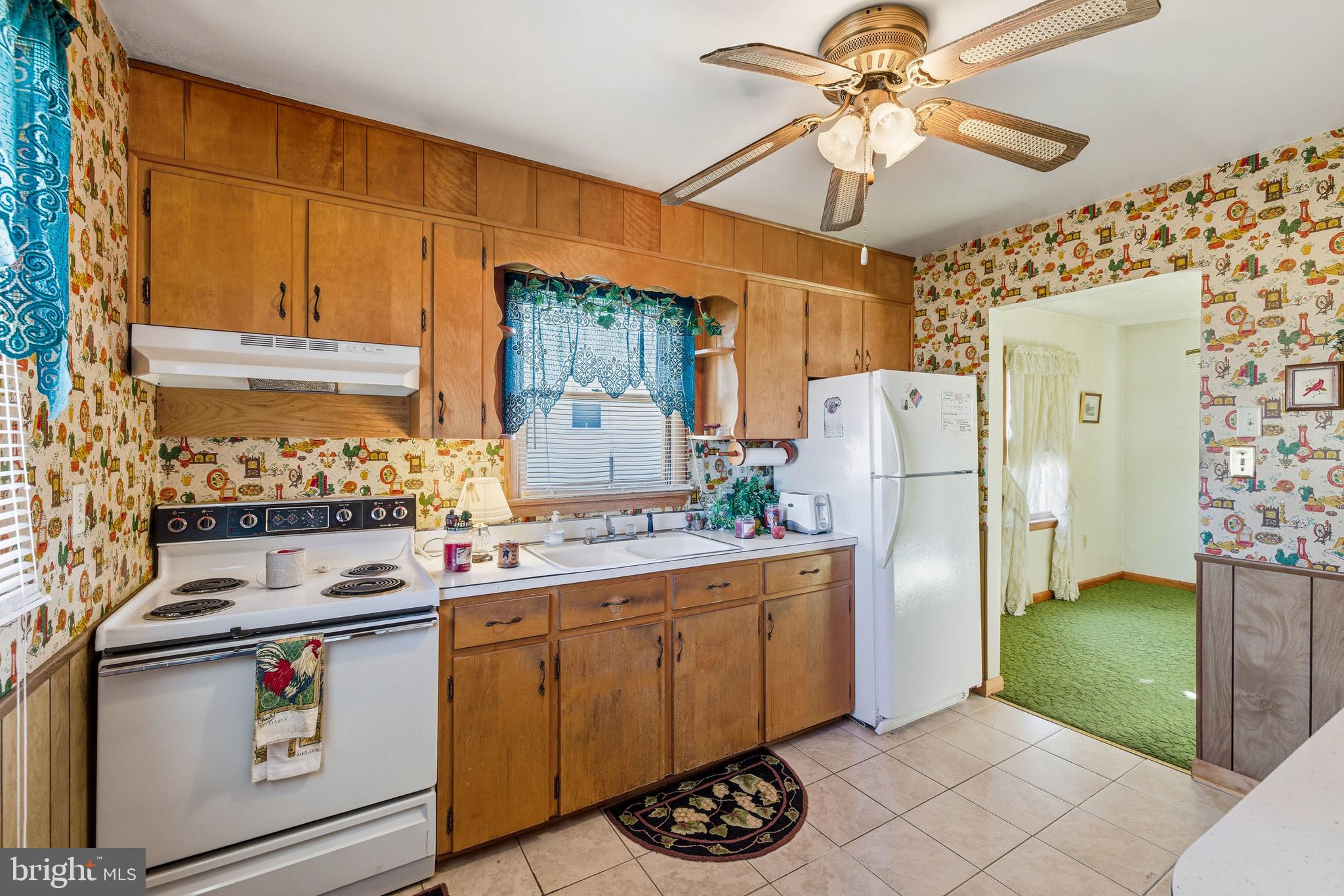 115 Sunset Drive Stanley, VA 22851 - Photo 6 of 56 a kitchen with a refrigerator a stove a sink and cabinets