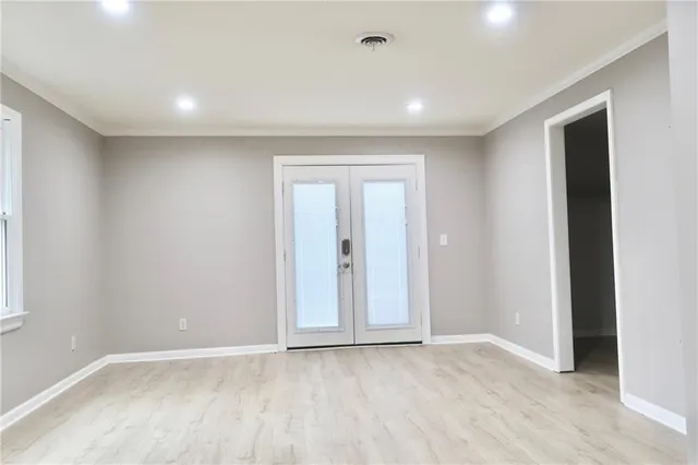 an empty room with windows and closet