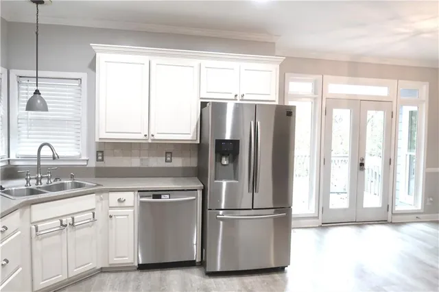 a white refrigerator freezer sitting inside of a kitchen
