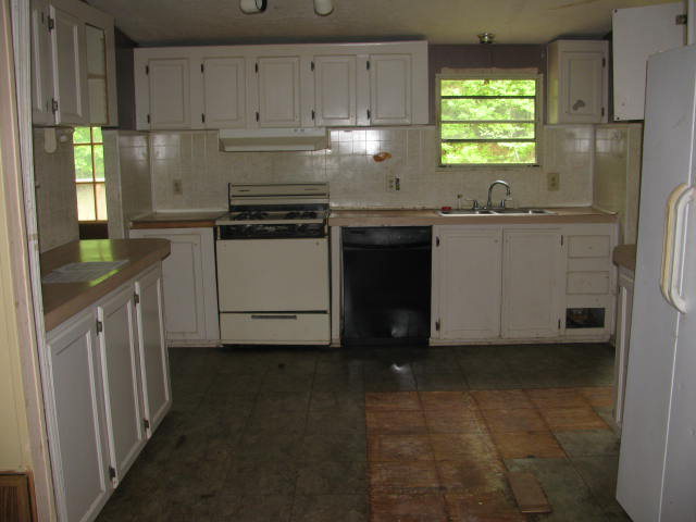 599 Rocky Creek Road Forsyth, GA 31029 - Photo 5 of 9 a kitchen with granite countertop a sink stainless steel appliances and cabinets