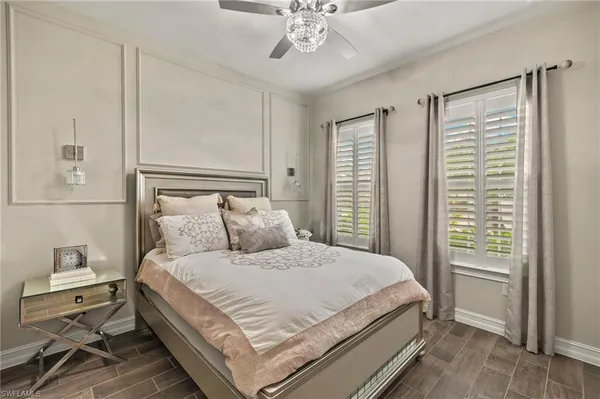 a bedroom with a bed and a chandelier