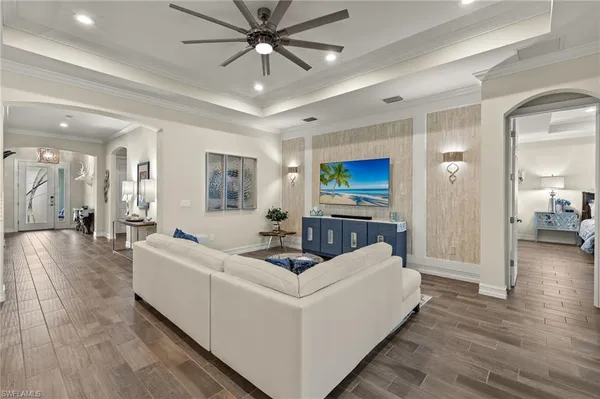 a living room with furniture and a wooden floor
