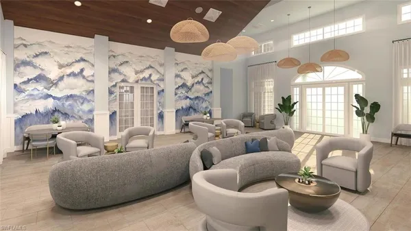 a large room with lots of white furniture and a chandelier