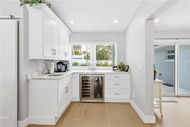 a kitchen with stainless steel appliances white cabinets and a stove