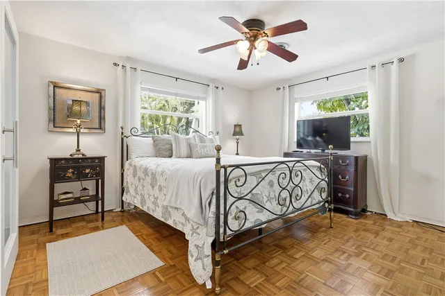 a bedroom with a large bed and a flat tv screen