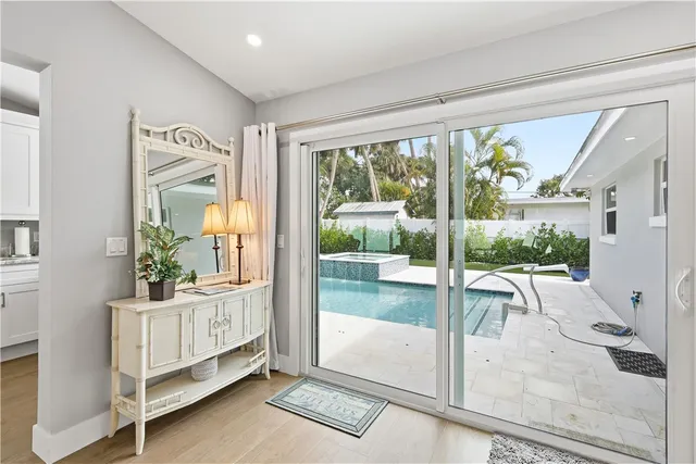 a view of a bedroom with balcony and floor to ceiling window