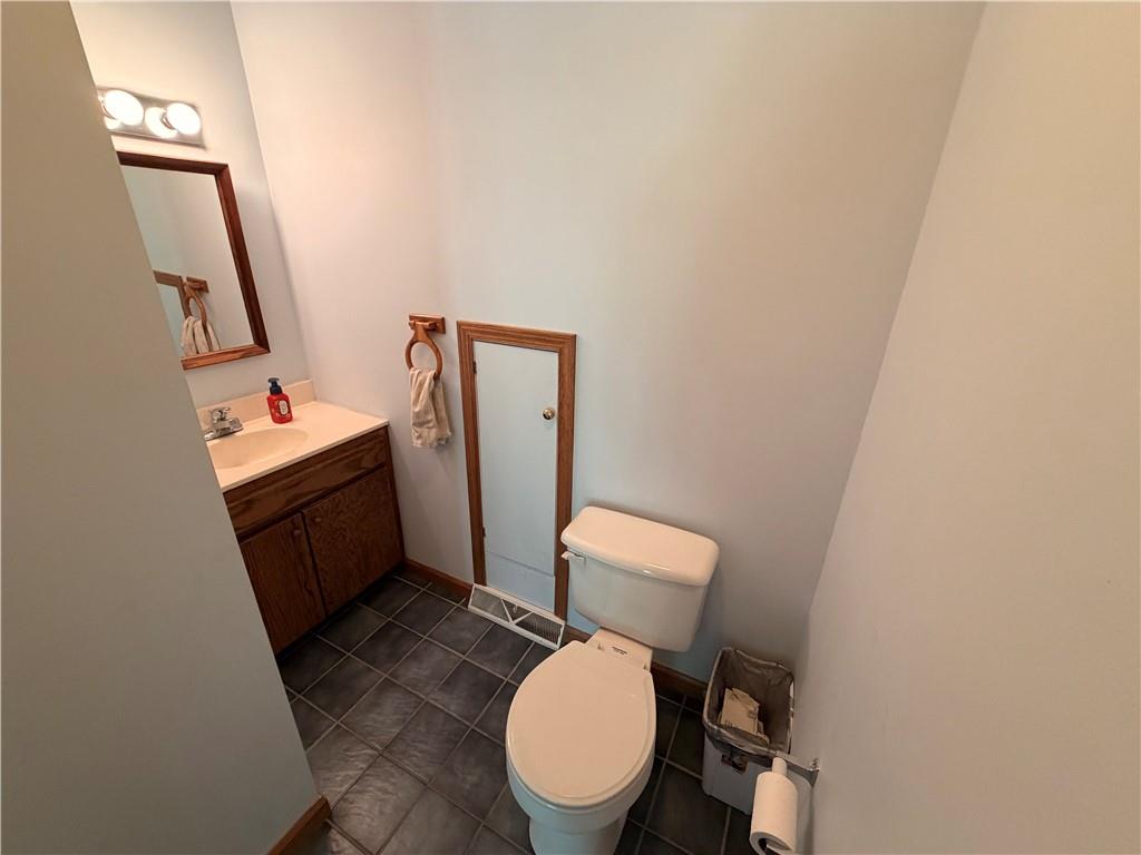 526 East River Road Edinburg, PA 16116 - Photo 19 of 45 a white toilet sitting next to a sink and a mirror