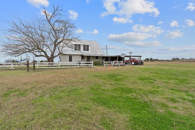 a view of a house with yard and sitting area
