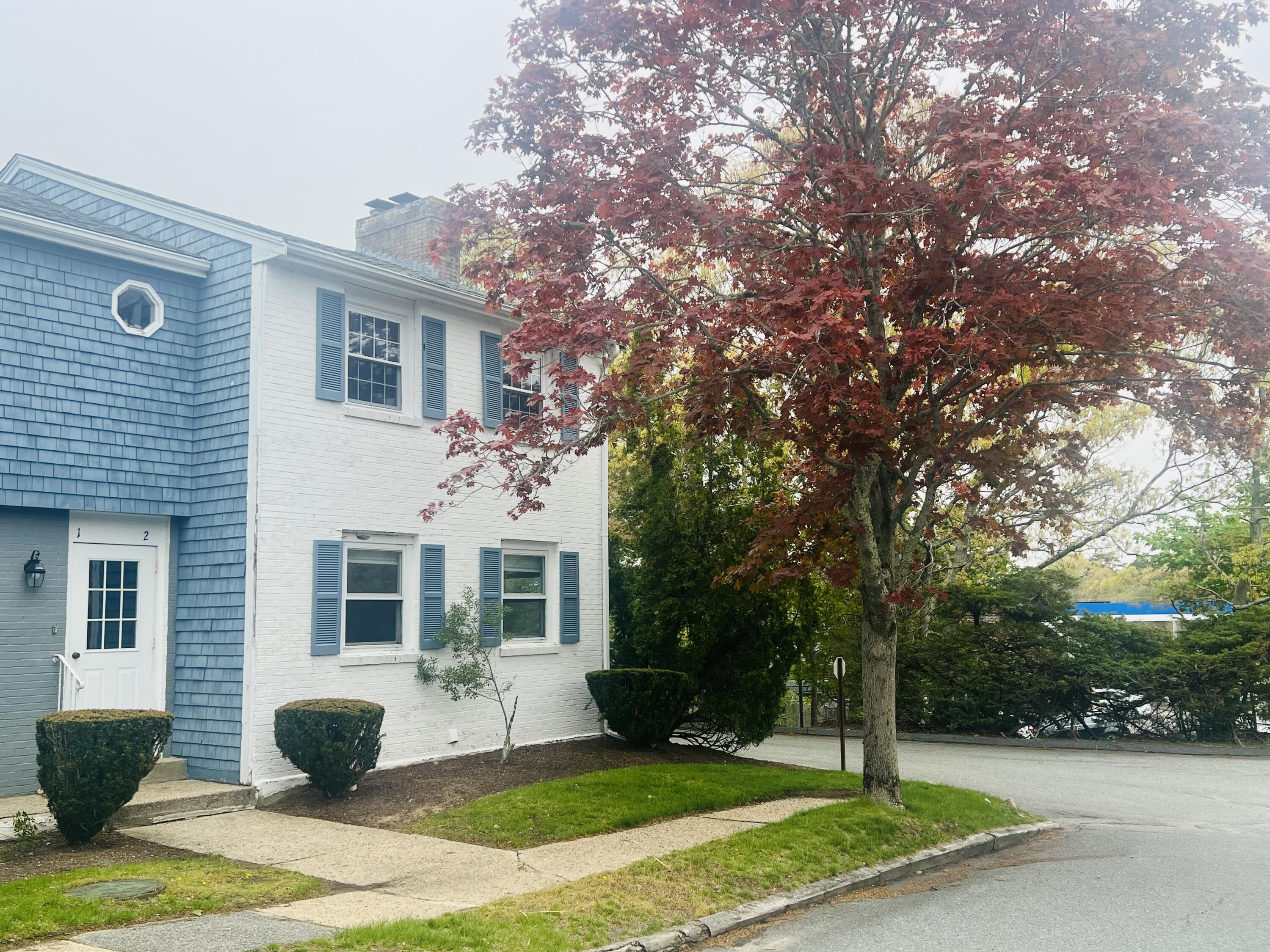 1431 Iyannough Road, Unit 1 Centerville, MA 02632 - Photo 22 of 28 a front view of a house with garden