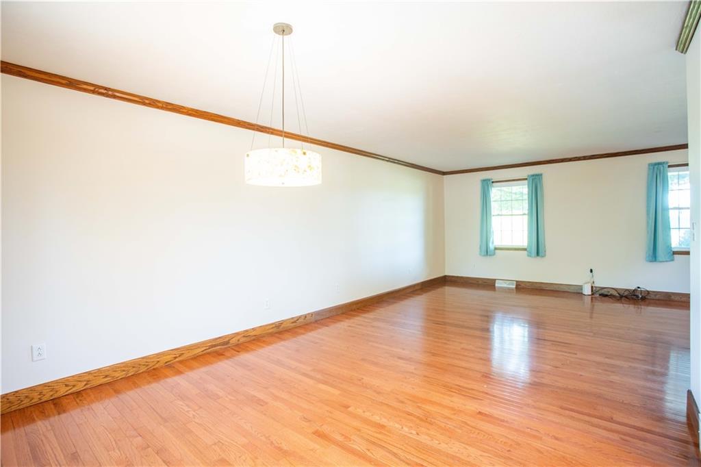 103 Mowry Road Monaca, PA 15061 - Photo 11 of 38 a view of an empty room with wooden floor and a window