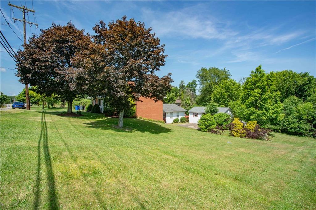 103 Mowry Road Monaca, PA 15061 - Photo 30 of 38 a backyard of a house with lots of green space and garden view