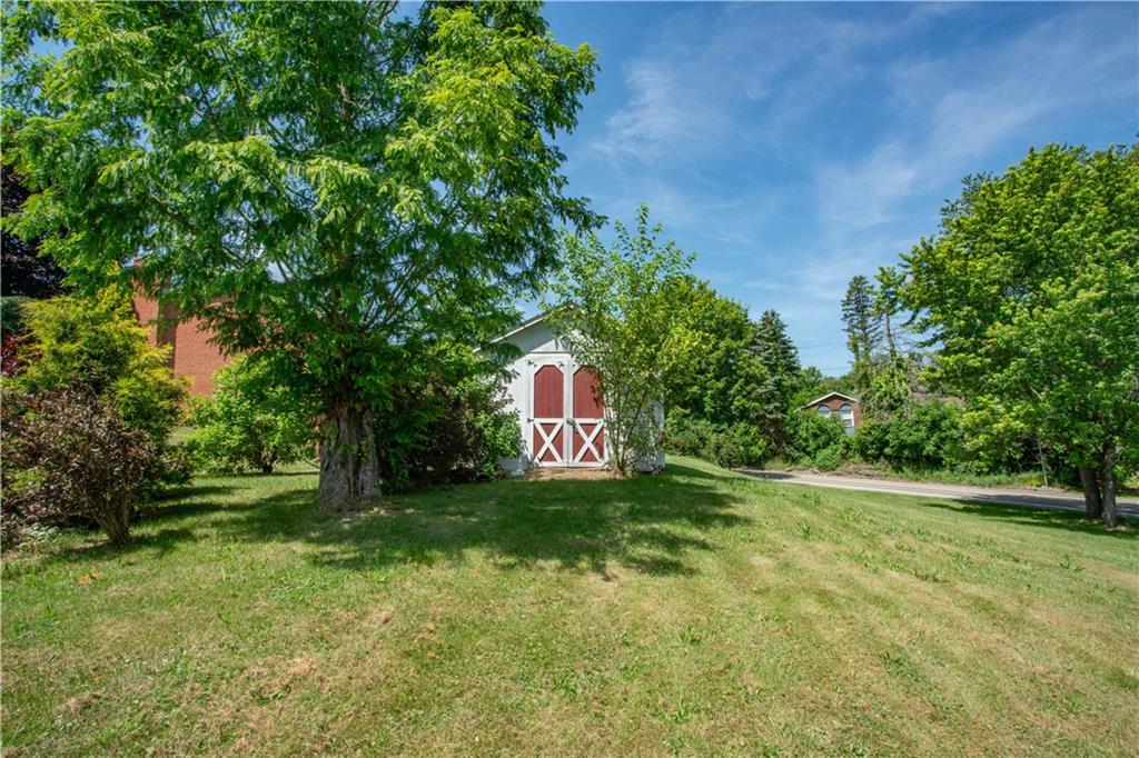 103 Mowry Road Monaca, PA 15061 - Photo 31 of 38 a sign that is sitting in the grass with tress in the background