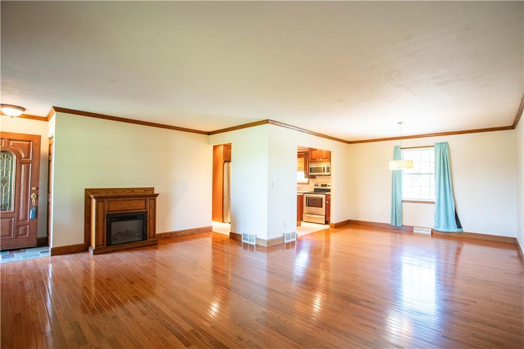 103 Mowry Road Monaca, PA 15061 - Photo 7 of 38 a view of an empty room with a fireplace and a window