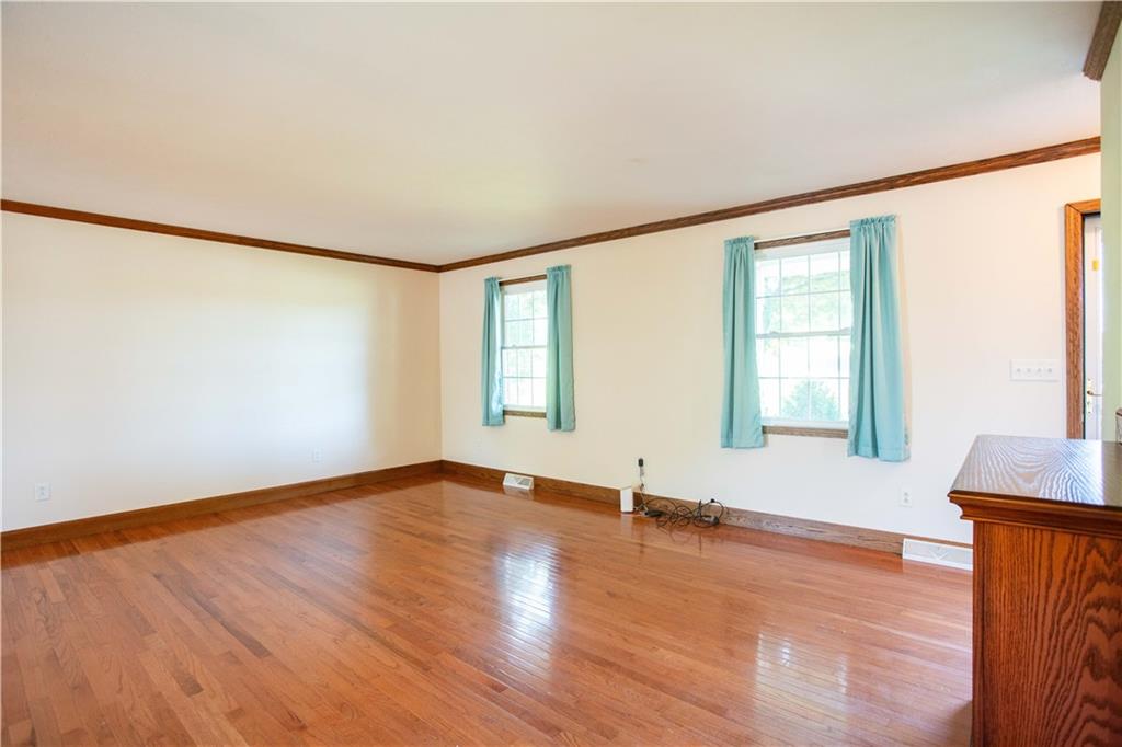 103 Mowry Road Monaca, PA 15061 - Photo 8 of 38 an empty room with wooden floor and windows
