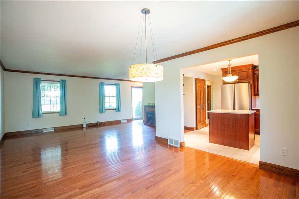 103 Mowry Road Monaca, PA 15061 - Photo 10 of 38 a view of an empty room with window and wooden floor