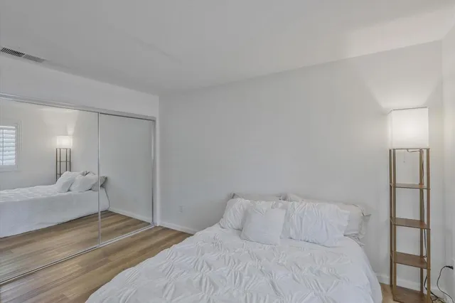 a bedroom with a bed and a lamp