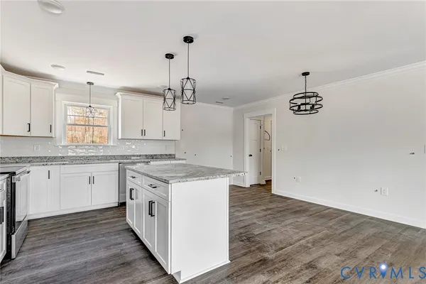 a kitchen with a stove a sink and a refrigerator