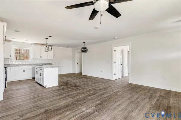 a view of a kitchen with a sink and dishwasher with wooden floor