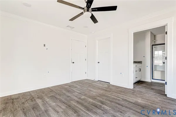 a view of empty room with wooden floor