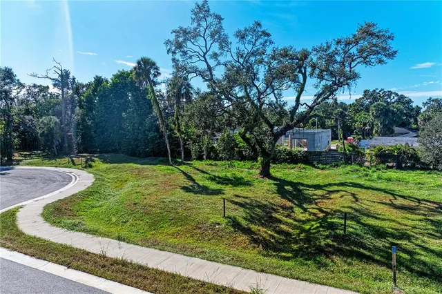 an aerial view of residential house with outdoor space and trees all around