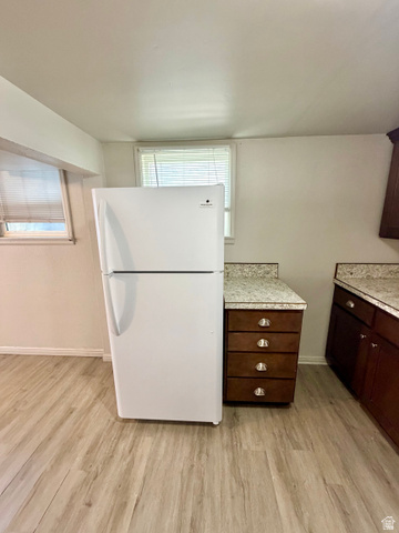 7 Foothill Boulevard Pocatello, ID 83204 - Photo 8 of 13 Kitchen area with wood-finish flooring, white walls, and a white refrigerator