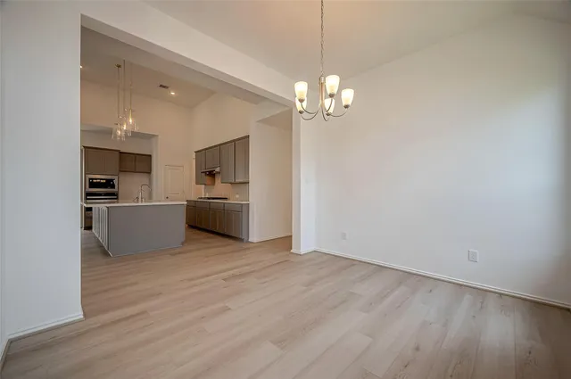 a view of a kitchen with a sink and wooden floor