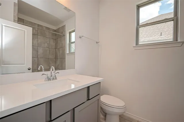 a bathroom with a sink toilet and a mirror