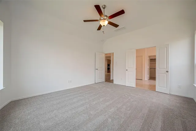 a view of a livingroom with a ceiling fan and window