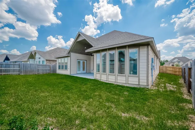 a view of a house with a backyard
