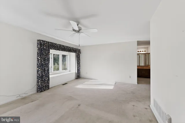 a view of an empty room with a fireplace