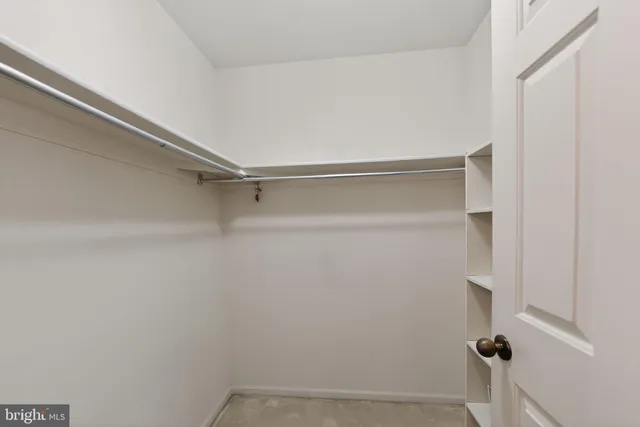 an empty room with a ceiling fan and a window