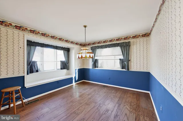 a view of room with wooden floor and window