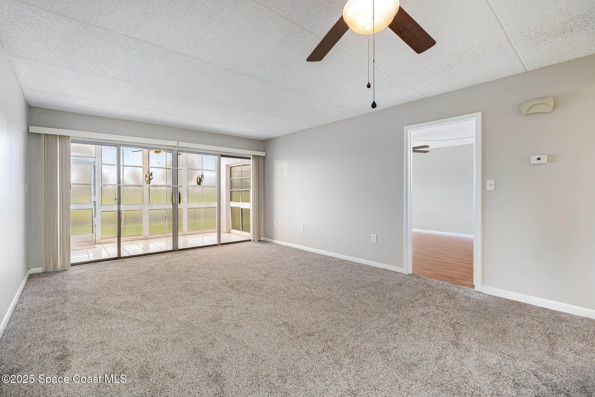 2727 North Wickham Road, Unit 10210 Melbourne, FL 32935 - Photo 13 of 35 a view of an empty room with a window