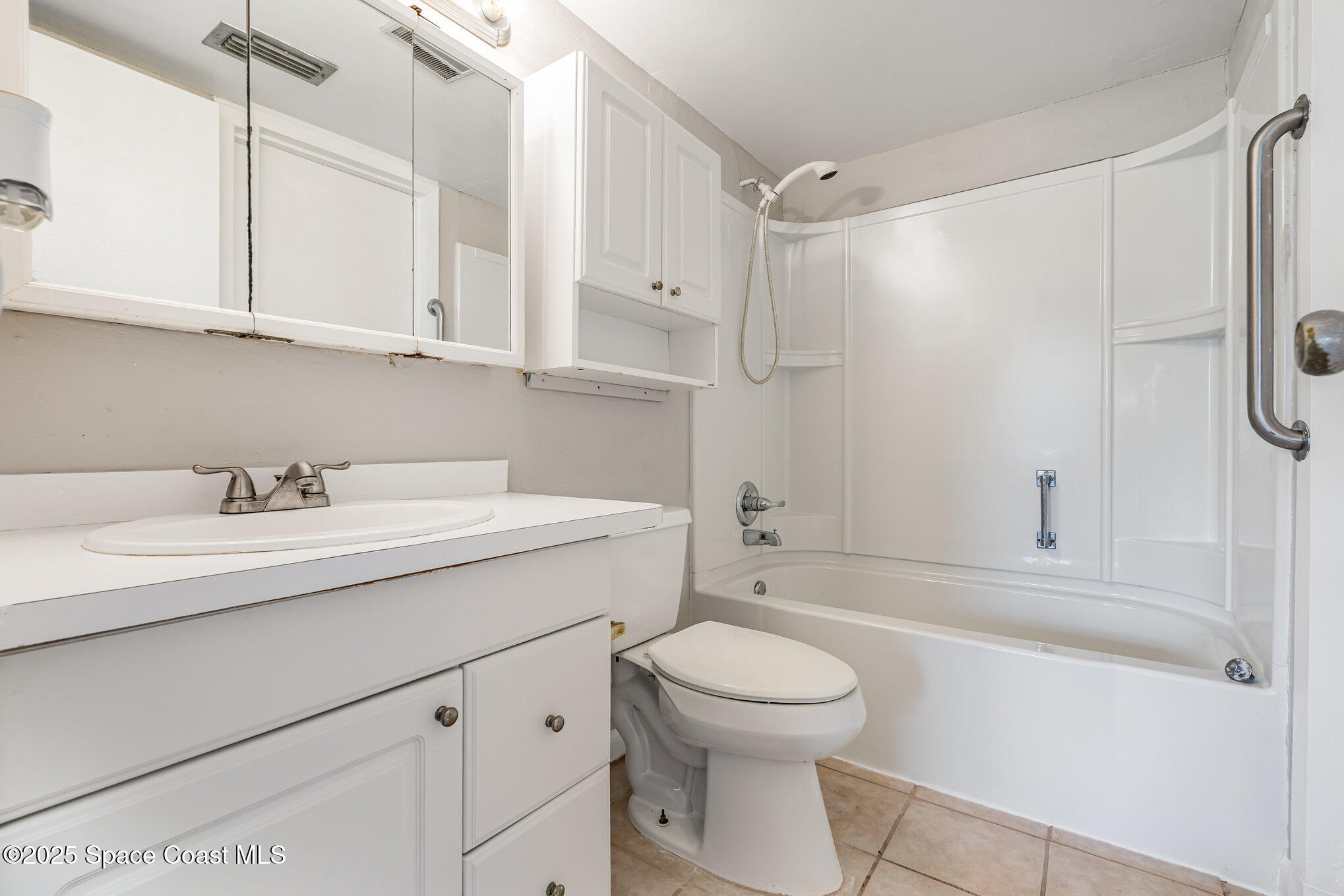 2727 North Wickham Road, Unit 10210 Melbourne, FL 32935 - Photo 17 of 35 a bathroom with a sink a toilet and shower
