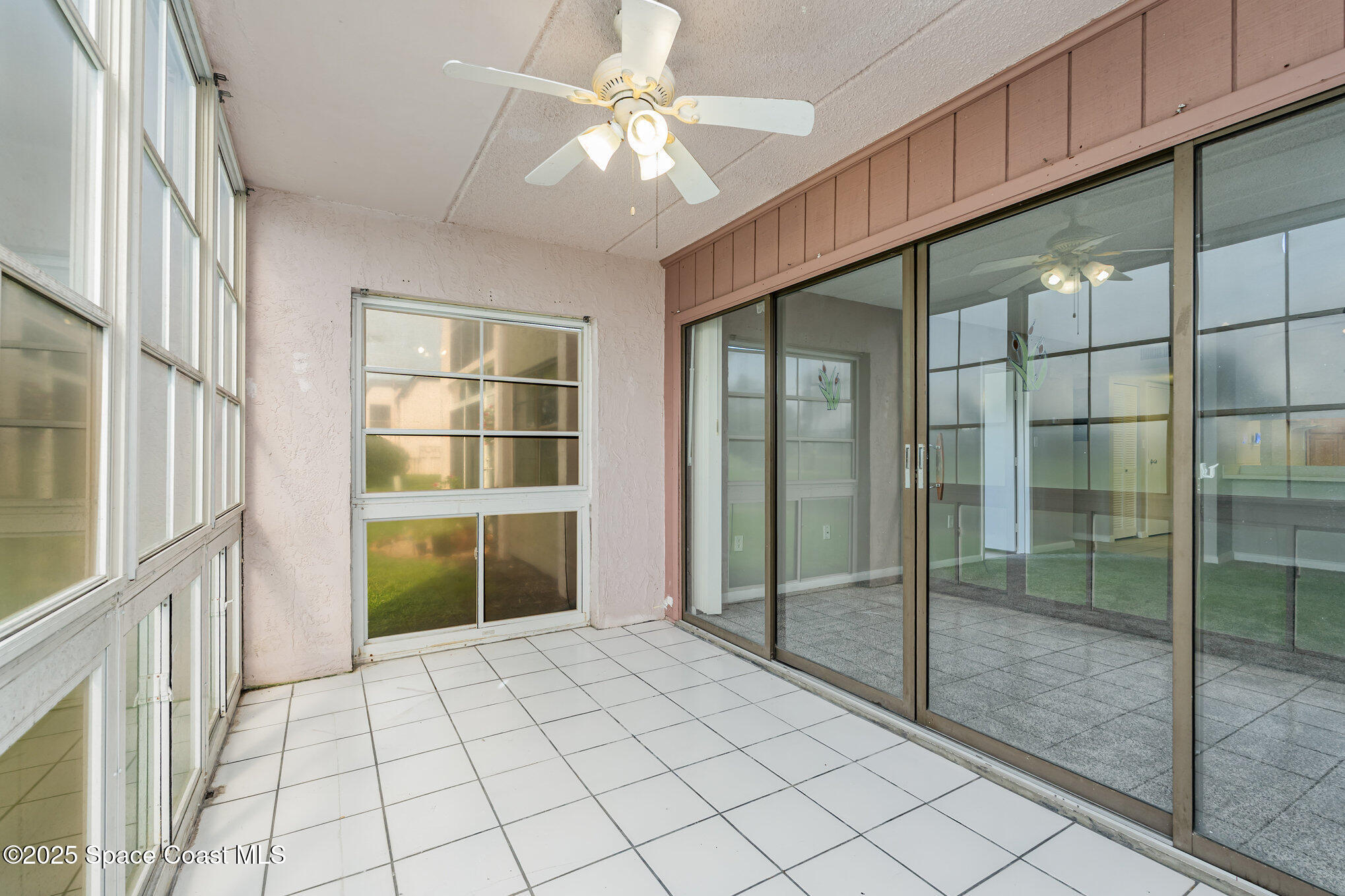 2727 North Wickham Road, Unit 10210 Melbourne, FL 32935 - Photo 18 of 35 a room with window and a chandelier